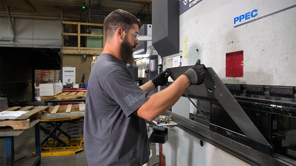 Worker bending sheet metal 