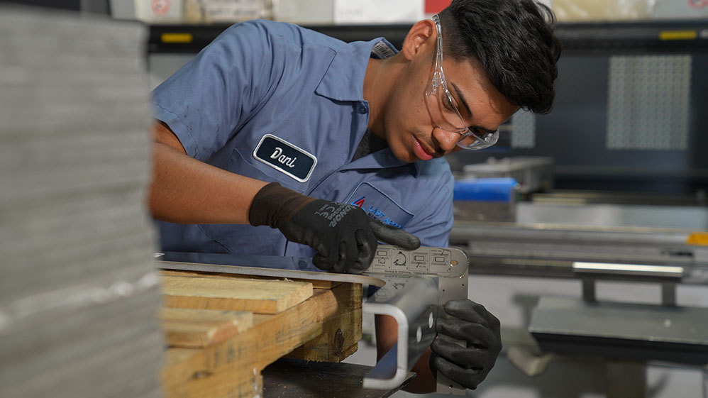 Factory worker taking measurements