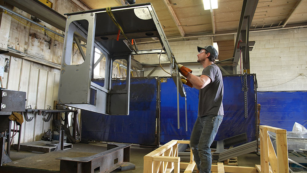 Manufacturing worker moving operator cab