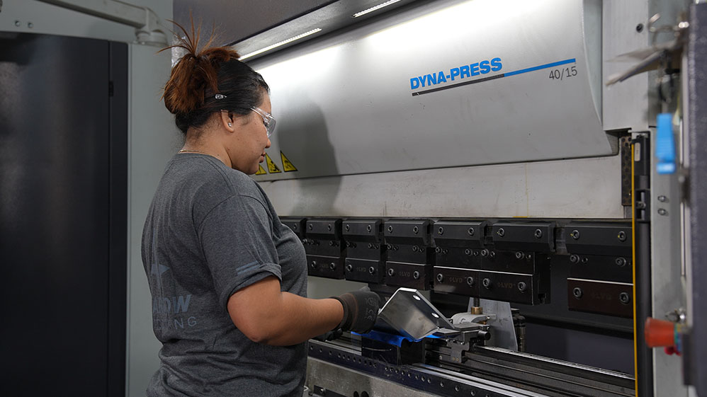 worker holding metal in press brake - dyna-press, wilson tool