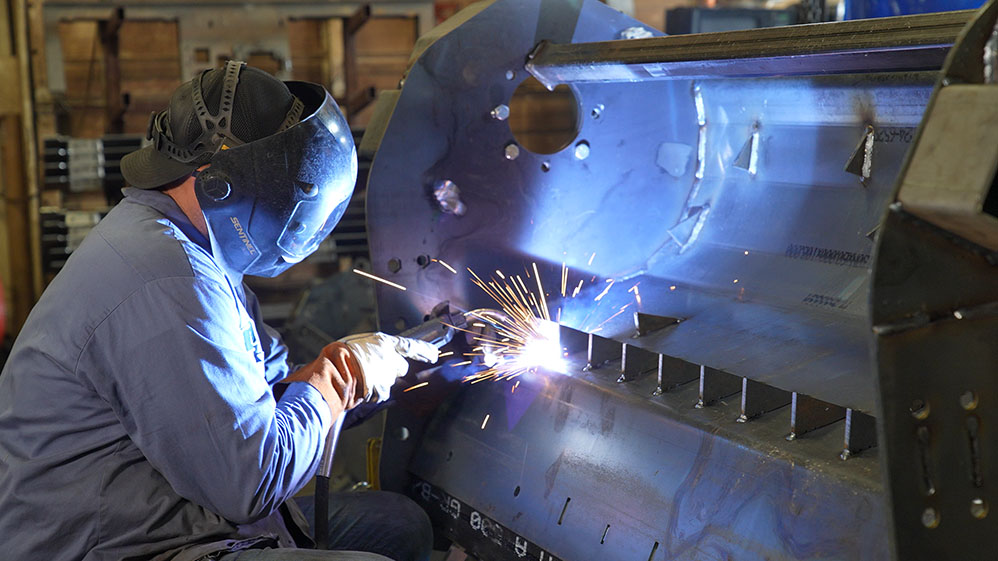 Welder working on a large metal structure